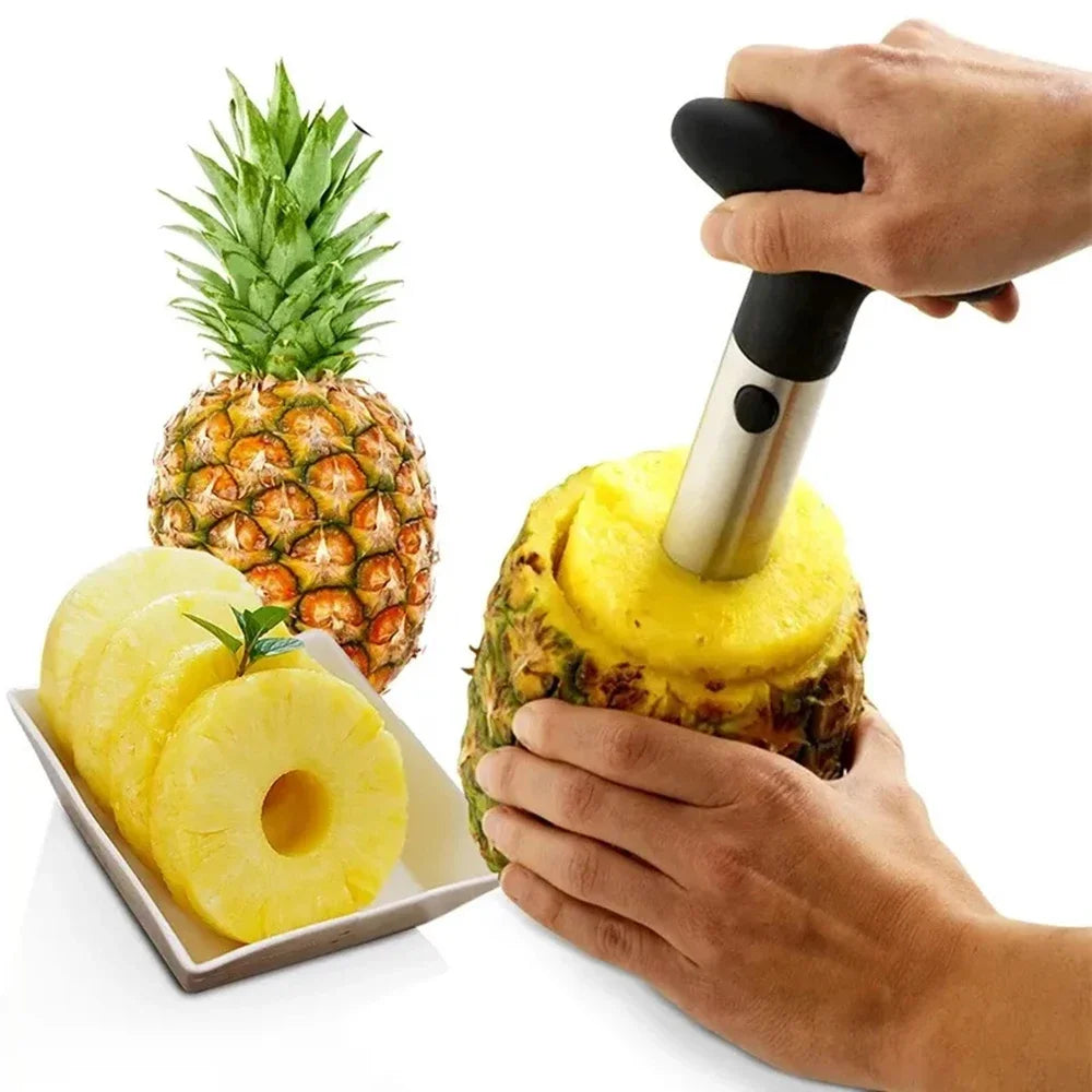 Hand twisting the corer into a pineapple, with a plate of sliced rings and a whole pineapple behind